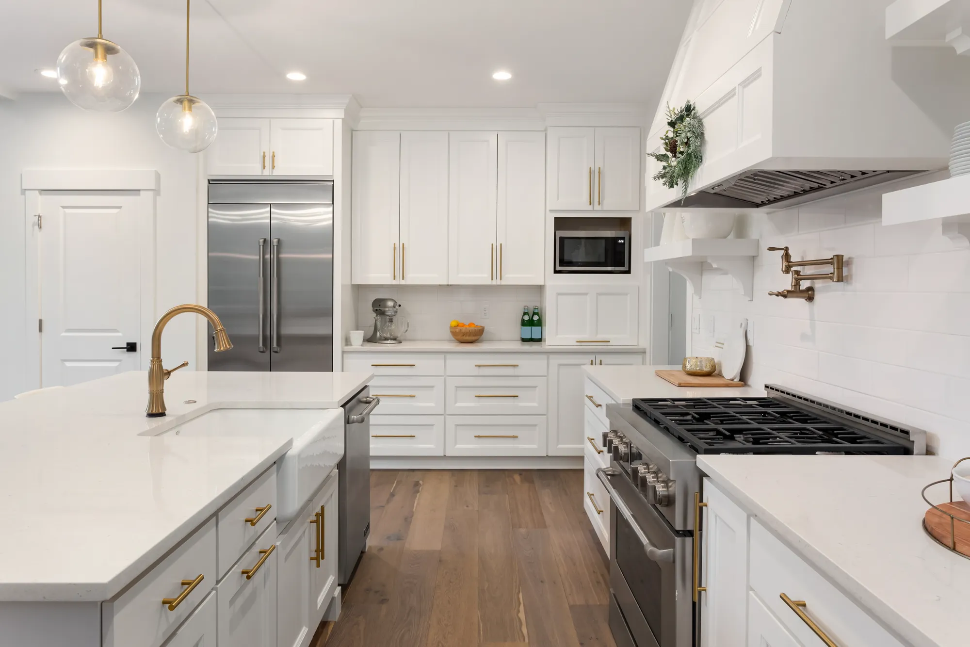 Bright white kitchen with a gold faucet